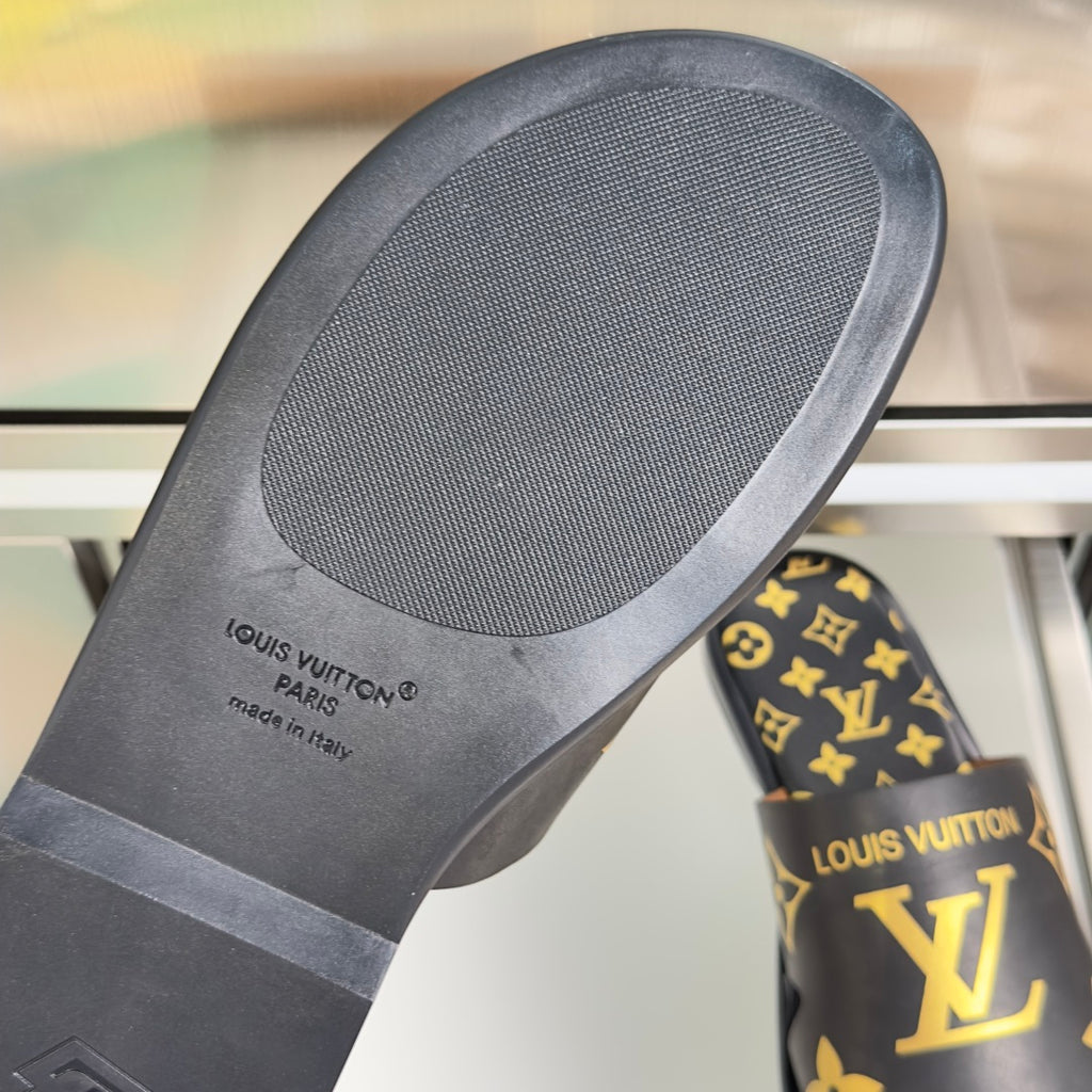 Black sandal footbed with textured tread and Louis Vuitton logo on heel