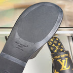 Black sandal footbed with textured tread and Louis Vuitton logo on heel