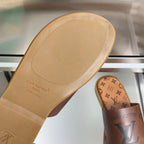 Louis Vuitton monogram slide sandal outsole, tan rubber tread and logo text