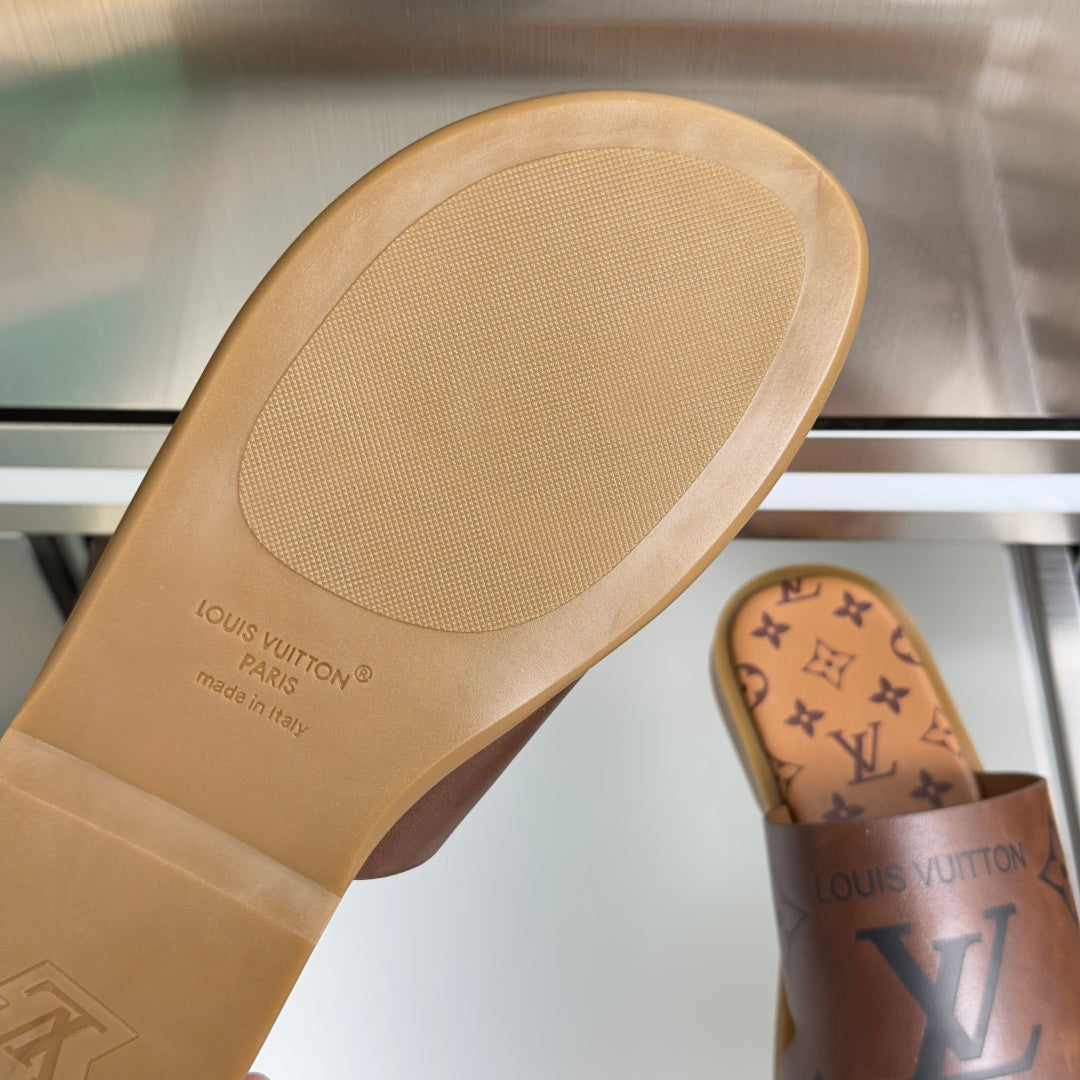 Louis Vuitton monogram slide sandal outsole, tan rubber tread and logo text