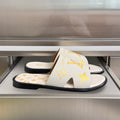 Louis Vuitton sandals: white strap with gold monogram, black slide sole