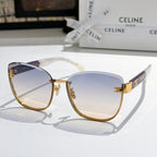 Gold-rim cat-eye sunglasses with blue gradient lenses and clear temples