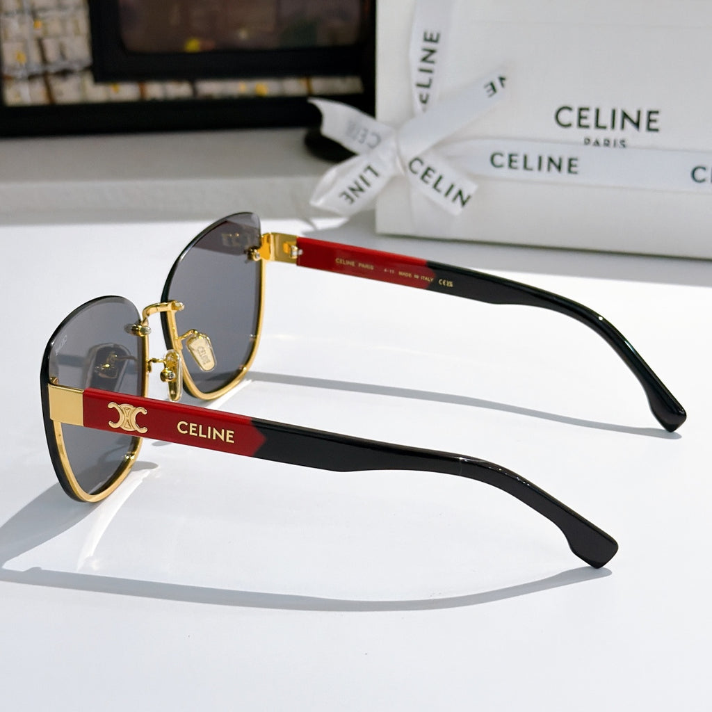 Side-view cat-eye sunglasses with dark lenses, red temple band, and gold tips