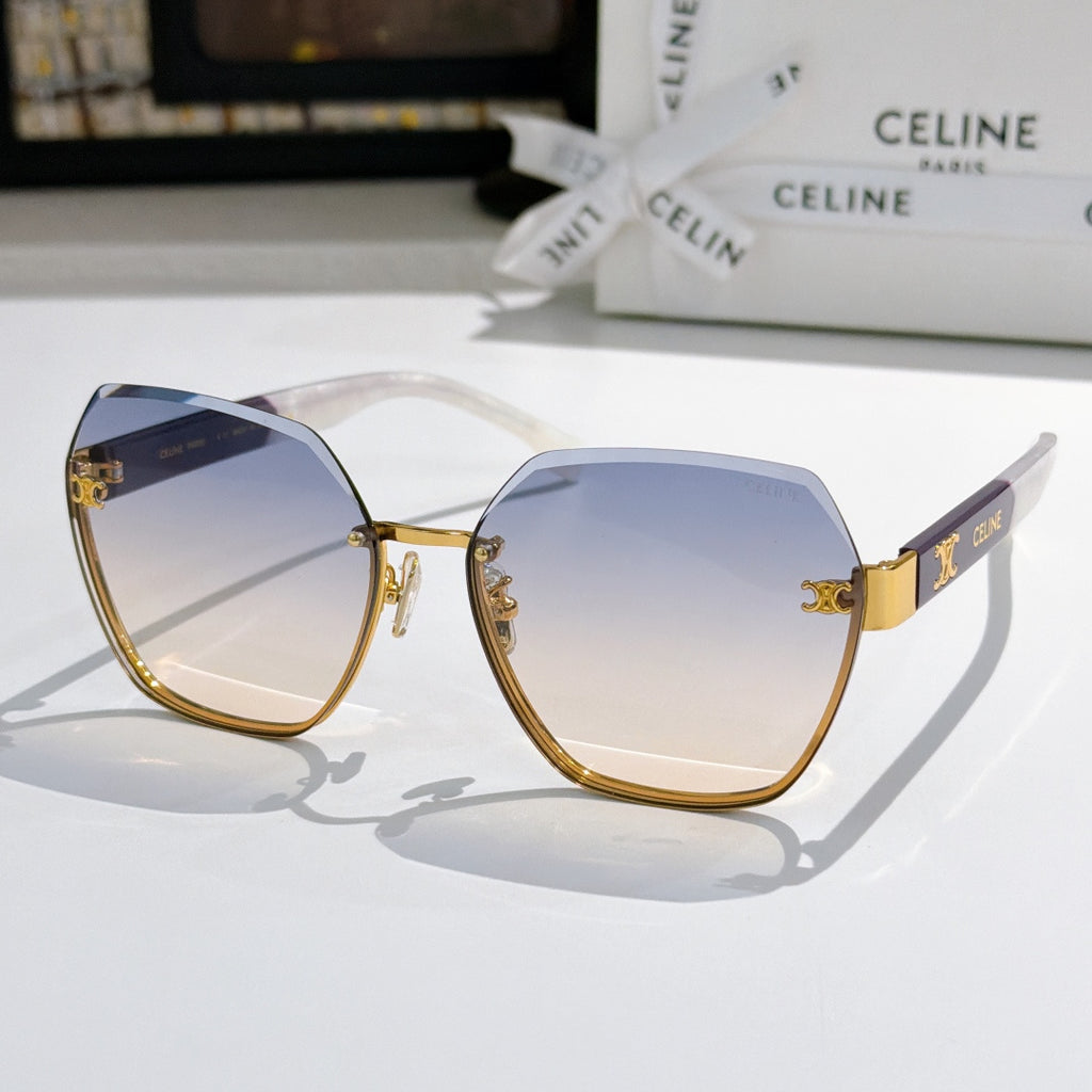 Celine sunglasses with navy frame, gold-tone accents, and light blue gradient lenses