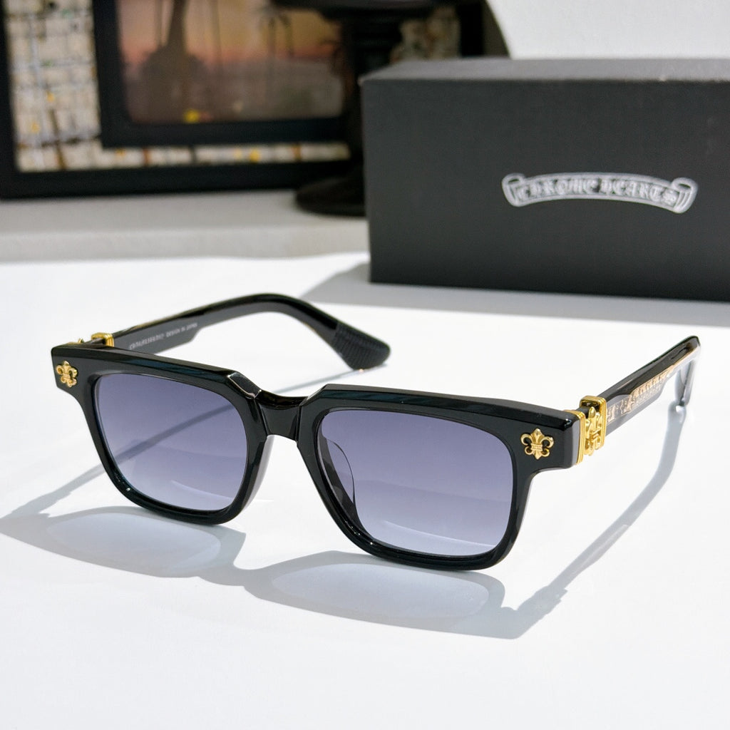 Black-frame sunglasses with dark lenses and gold-tone logo accents