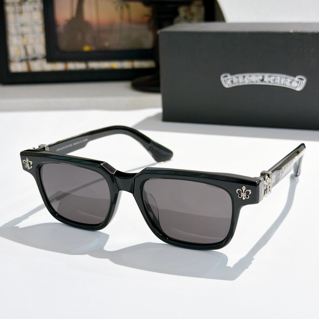 Black-frame sunglasses with dark lenses and silver-tone fleur-de-lis accents