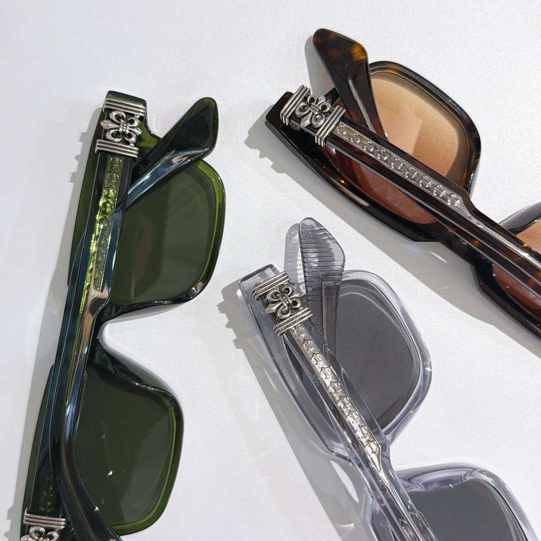 Overlapping sunglasses with green, tortoiseshell, and clear frames and tinted lenses