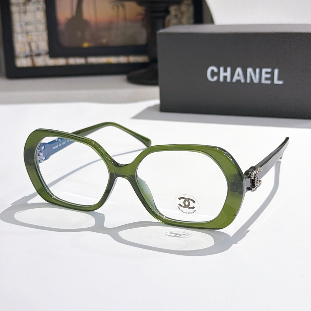 Chanel eyeglasses, green rounded-square frames with gold-tone temple logo and clear lenses