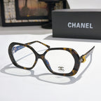 Chanel eyeglasses, dark tortoiseshell frames with gold-tone temple logo and clear lenses