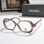 Chanel eyeglasses, rose frames with gold-tone temple logo and clear lenses