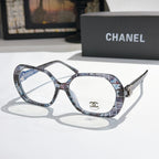 Chanel eyeglasses, blue-gray tortoiseshell frames with gold-tone temple logo and clear lenses