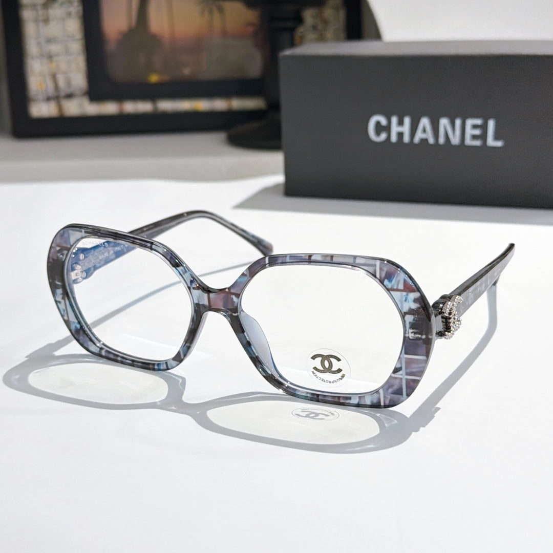 Chanel eyeglasses, blue-gray tortoiseshell frames with gold-tone temple logo and clear lenses