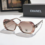 Chanel sunglasses, rose-brown frames, pink-tinted lenses, gold logo detail.