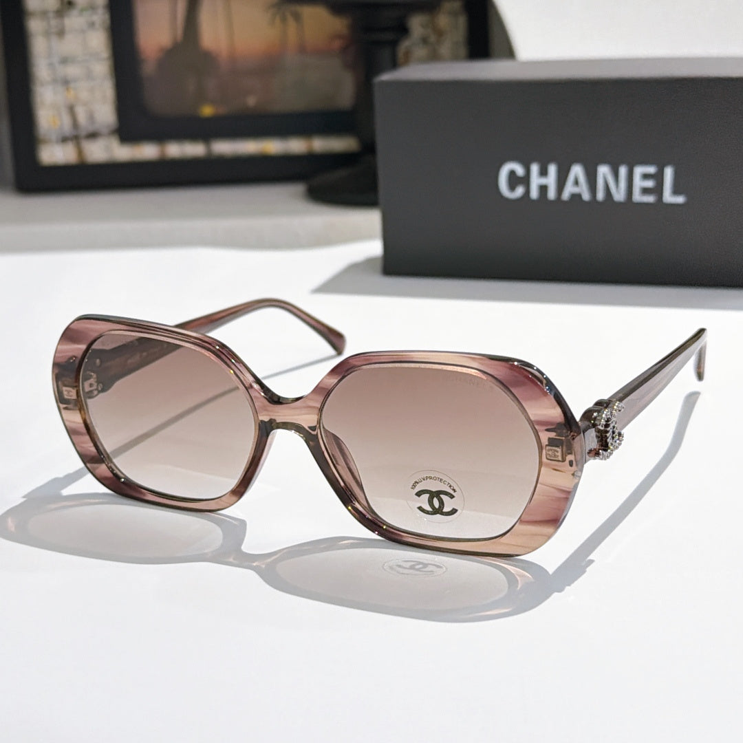 Chanel sunglasses, rose-brown frames, pink-tinted lenses, gold logo detail.