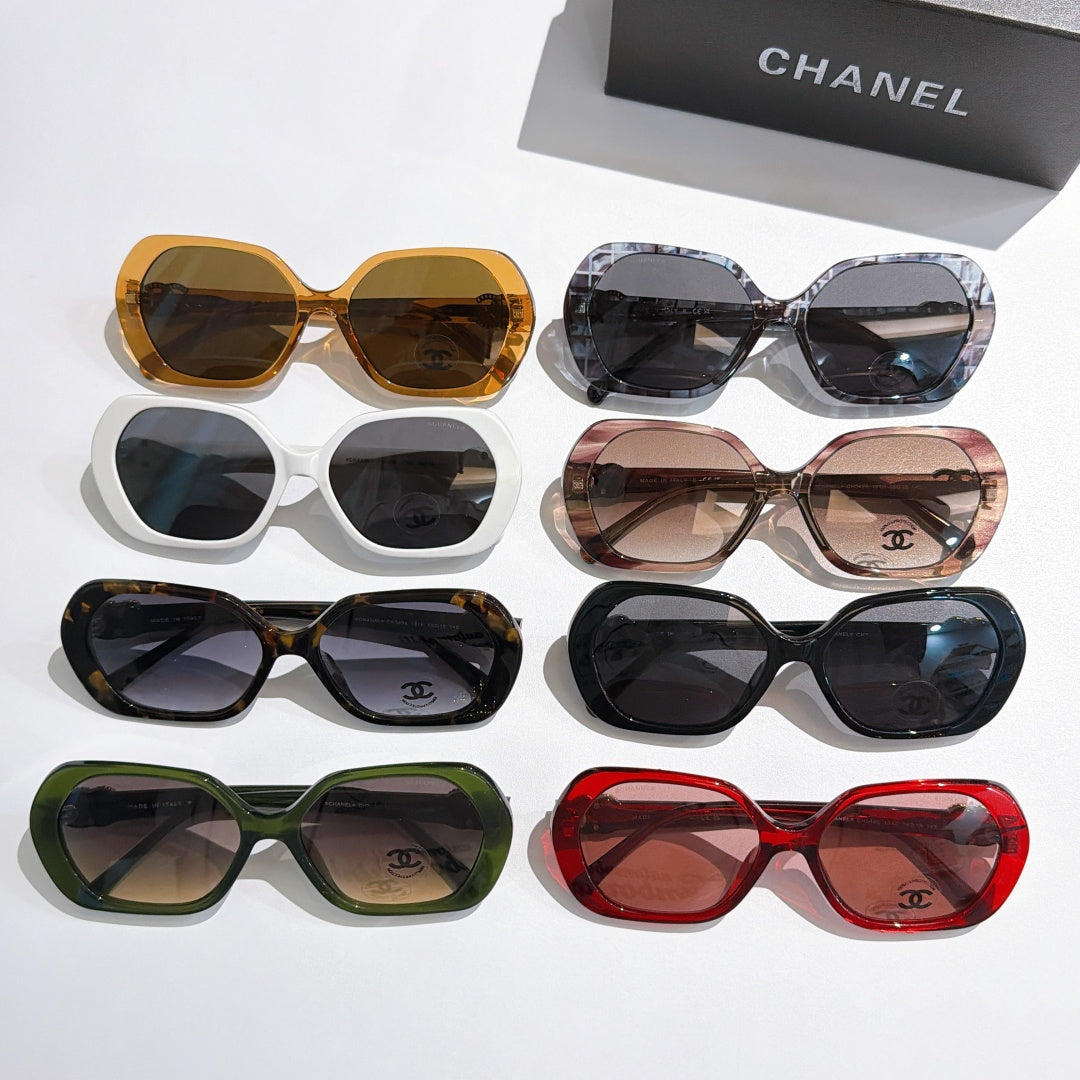 Chanel sunglasses assortment with amber, white, tortoiseshell, green, black, and red frames.