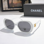 Chanel sunglasses, white frames, dark gray tinted lenses, gold logo detail.