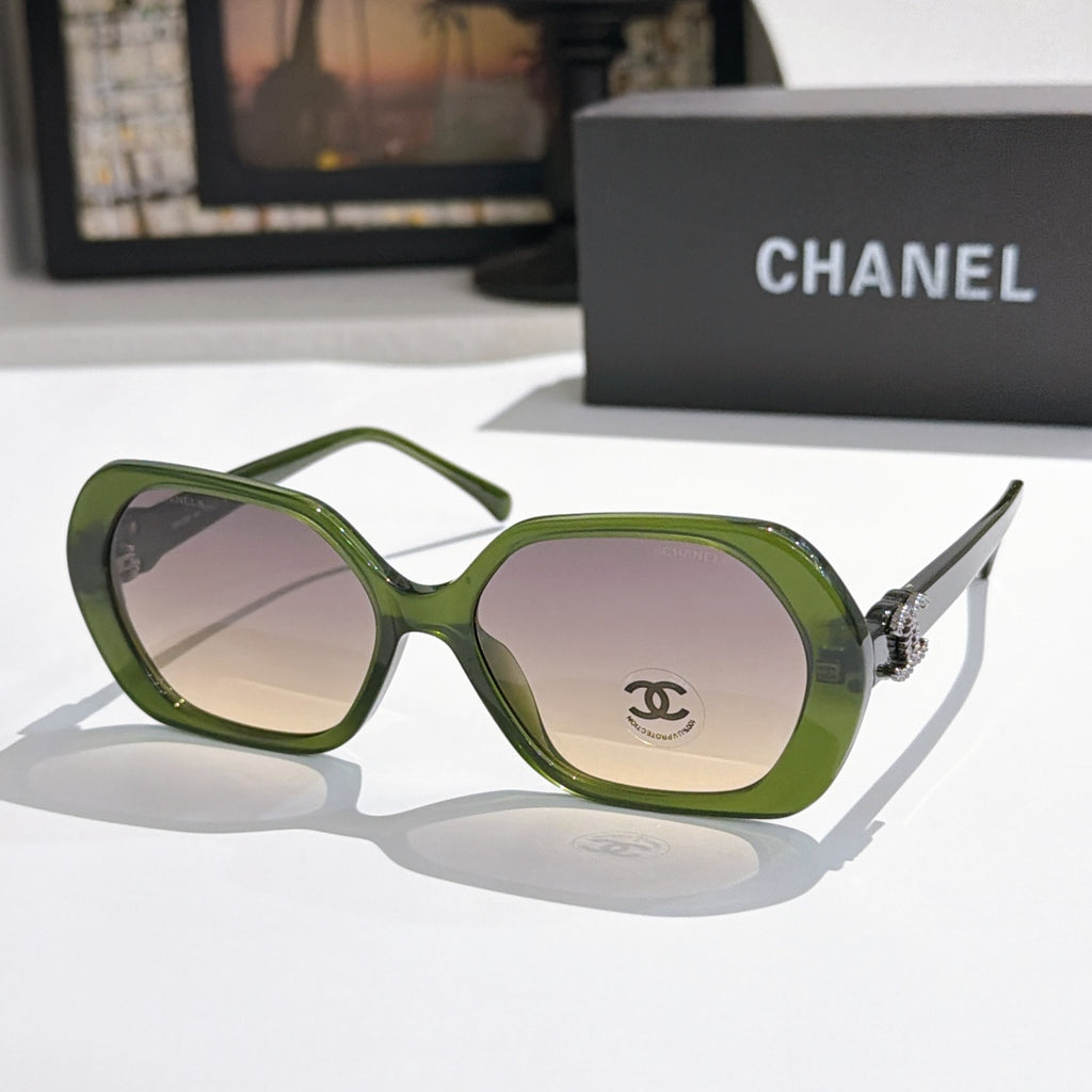 Chanel sunglasses, olive-green frames, pink-tinted lenses, gold logo detail.