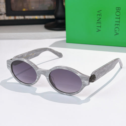 Bottega Veneta sunglasses, translucent light-gray frames with purple-tinted lenses