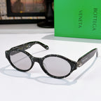 Bottega Veneta sunglasses, dark patterned frames with light-gray tinted lenses