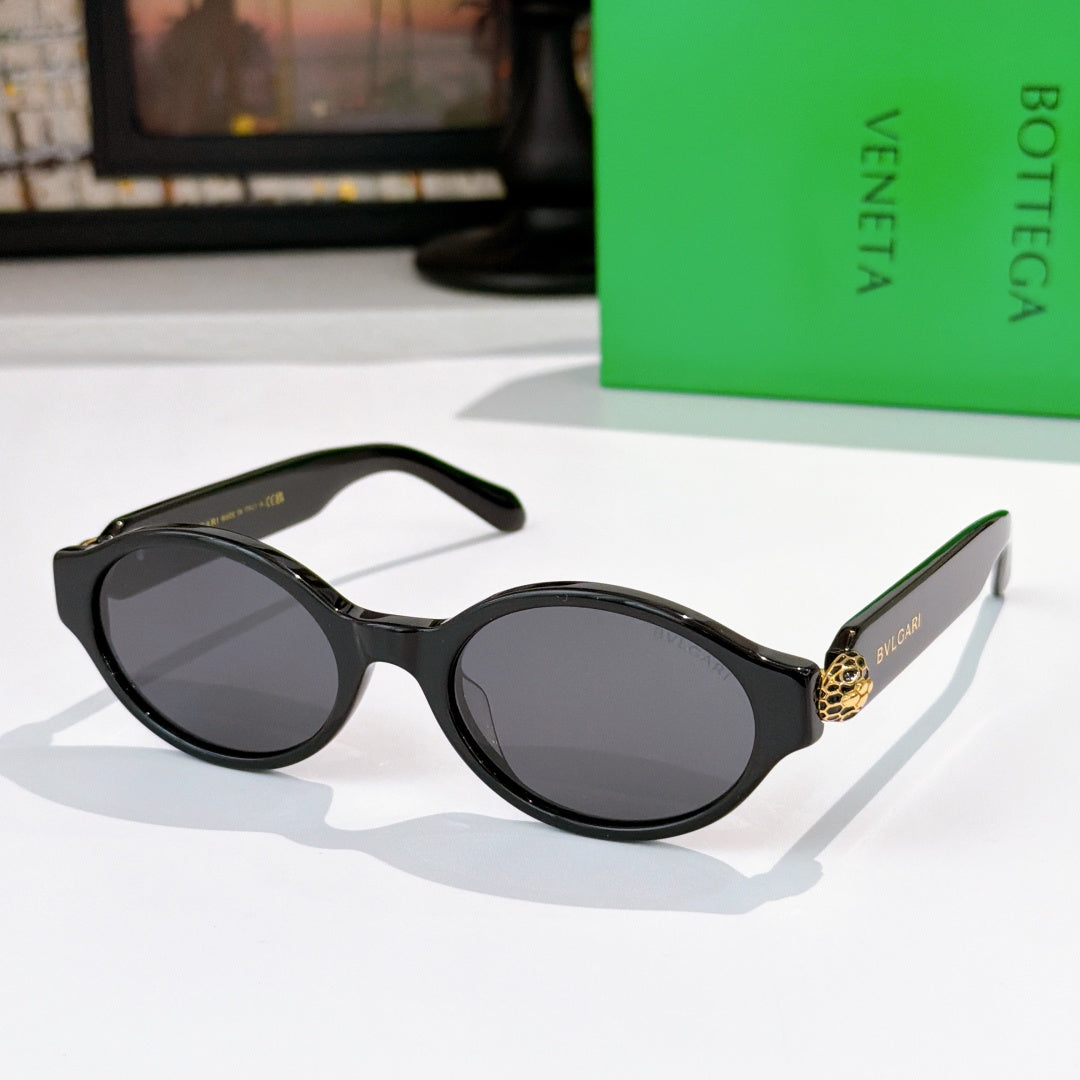 Bottega Veneta sunglasses, glossy black frames with dark lenses and gold temple detail