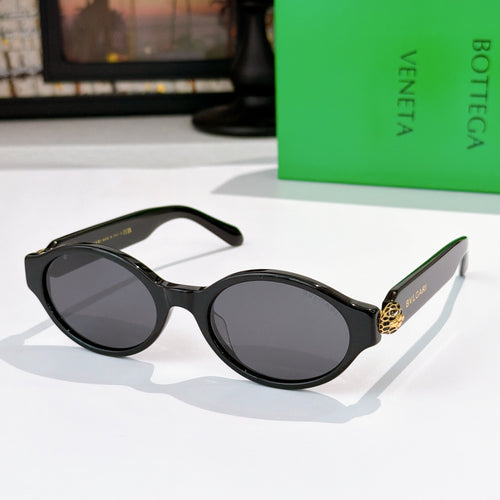 Bottega Veneta sunglasses, glossy black frames with dark lenses and gold temple detail