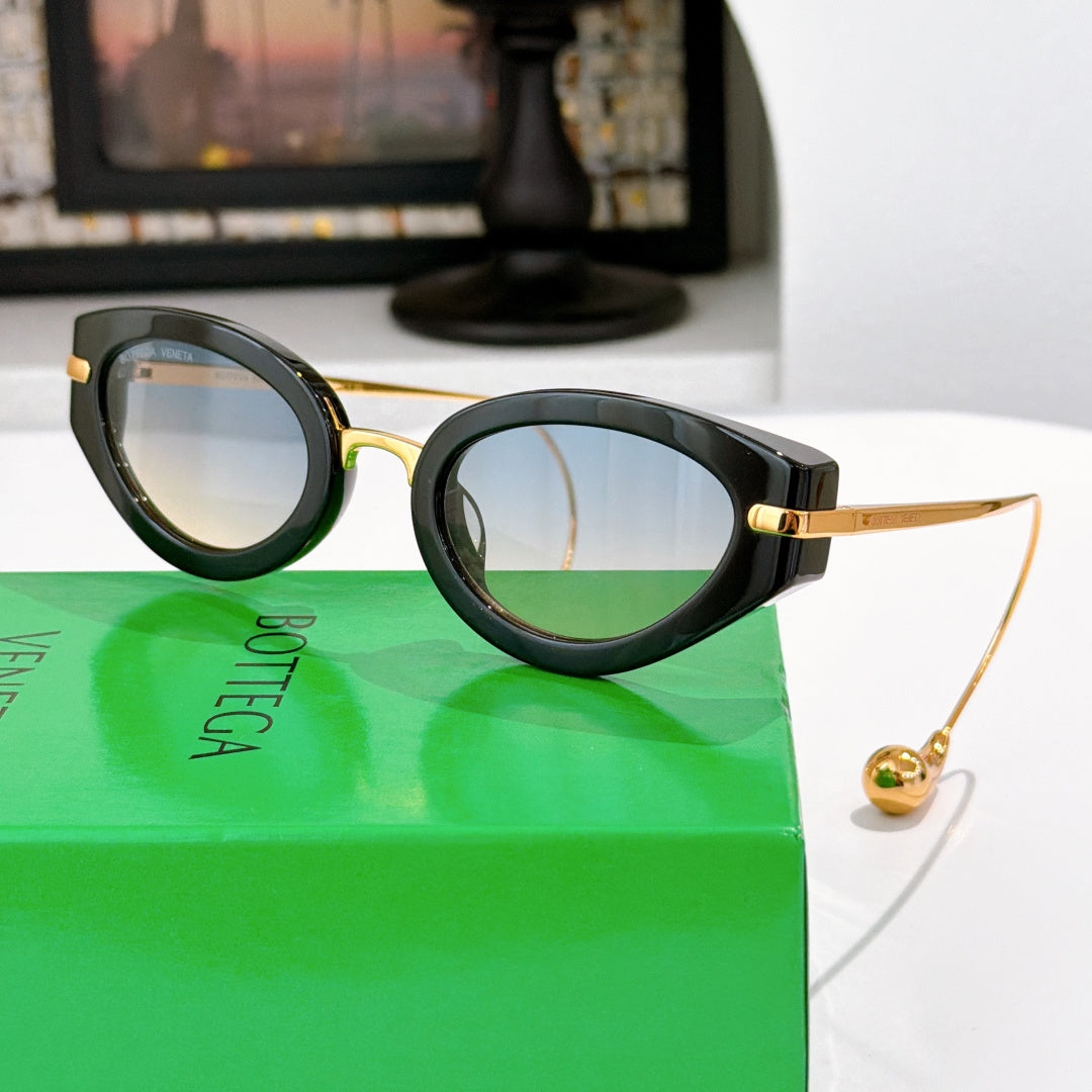 Bottega Veneta glasses with dark frames and amber tinted lenses, gold-tone temple detail