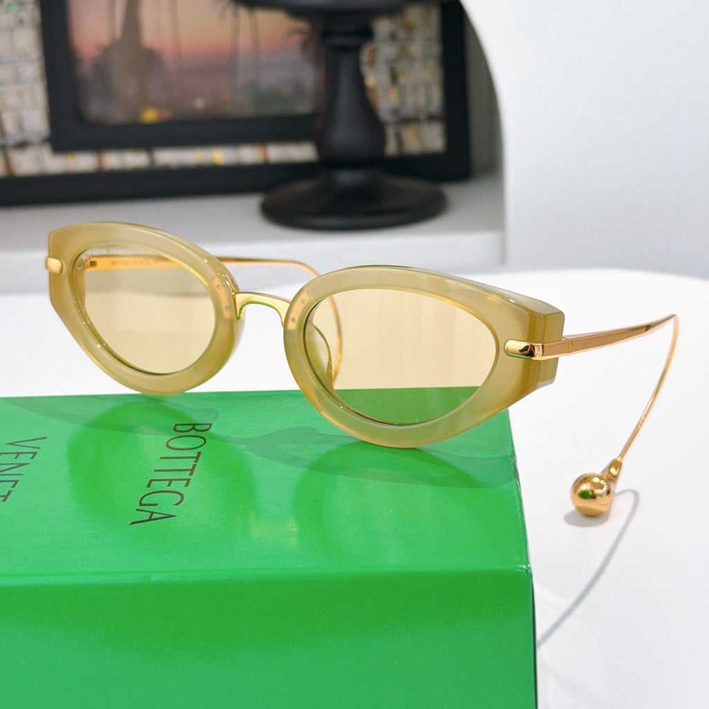 Bottega Veneta glasses with gold-tone frames and light amber tinted lenses, gold hardware