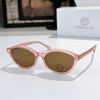 Round eyeglasses with translucent pink frames and brown tinted lenses
