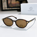 Round eyeglasses with dark tortoiseshell frames and brown tinted lenses