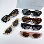 Assorted sunglasses laid out: black, tortoise, cream, and pink frames with lenses