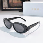 Black oval sunglasses with gray lenses and slim arms