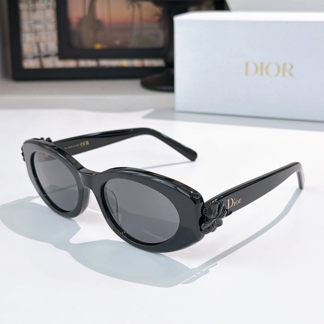 Black oval sunglasses with gray lenses and slim arms