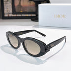 Dark oval sunglasses with tan lenses and glossy black frame