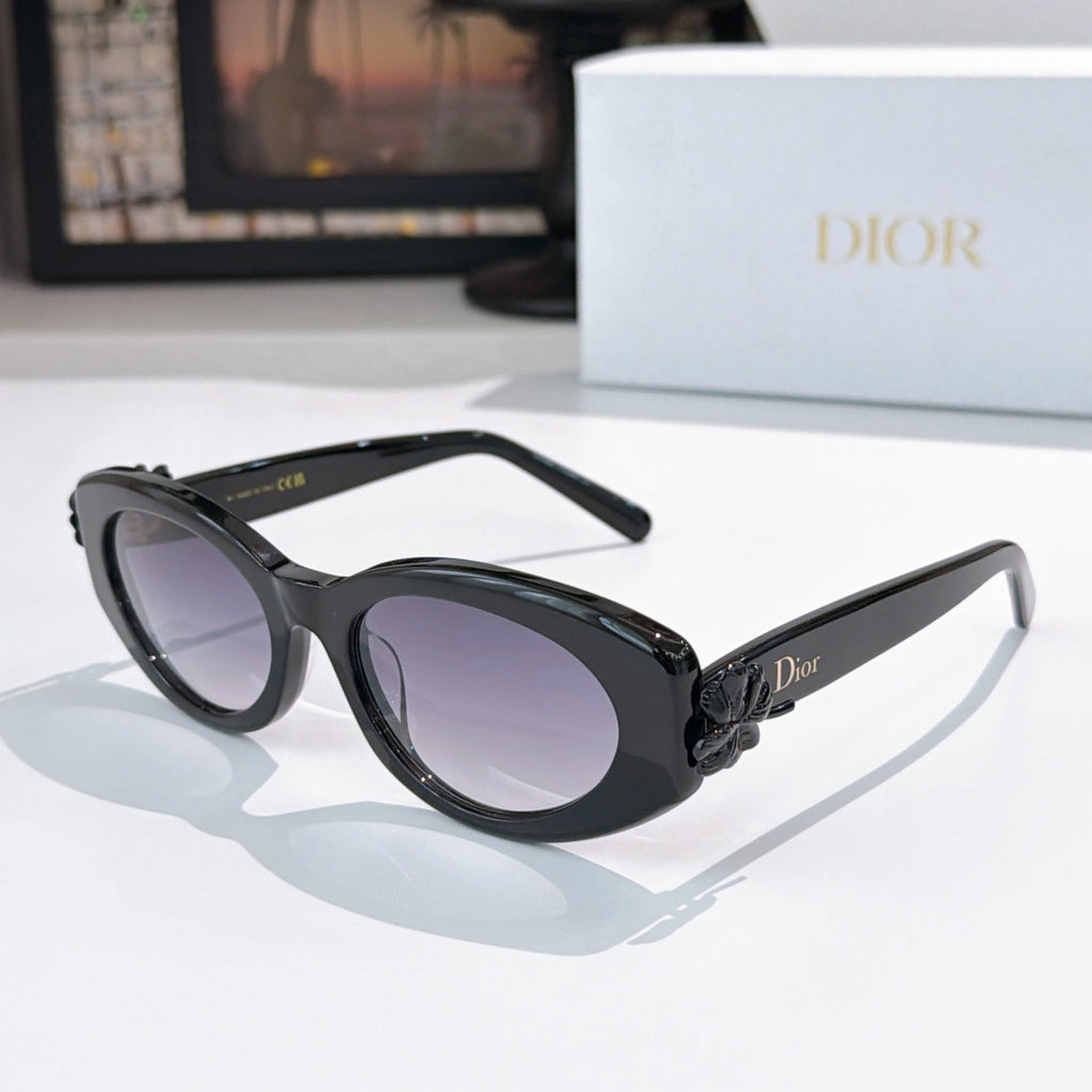 Black oval sunglasses with violet-tinted lenses and raised temple detail