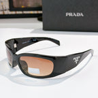 Prada black acetate glasses with tan lenses and gold-toned logo hardware