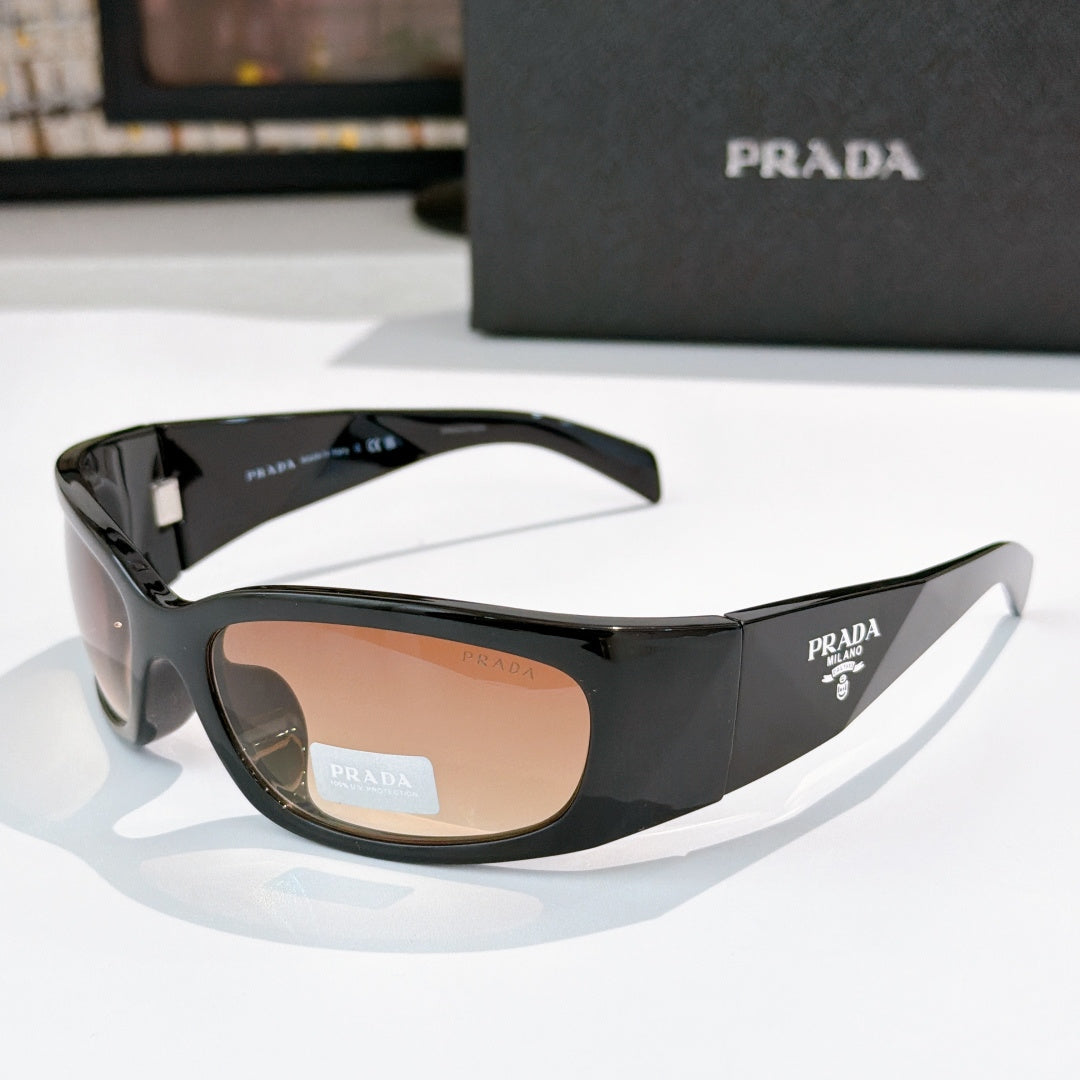 Prada black acetate glasses with tan lenses and gold-toned logo hardware