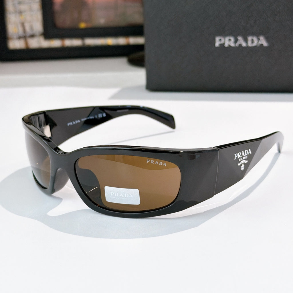 Prada dark acetate glasses with amber-tinted lenses and logo hardware