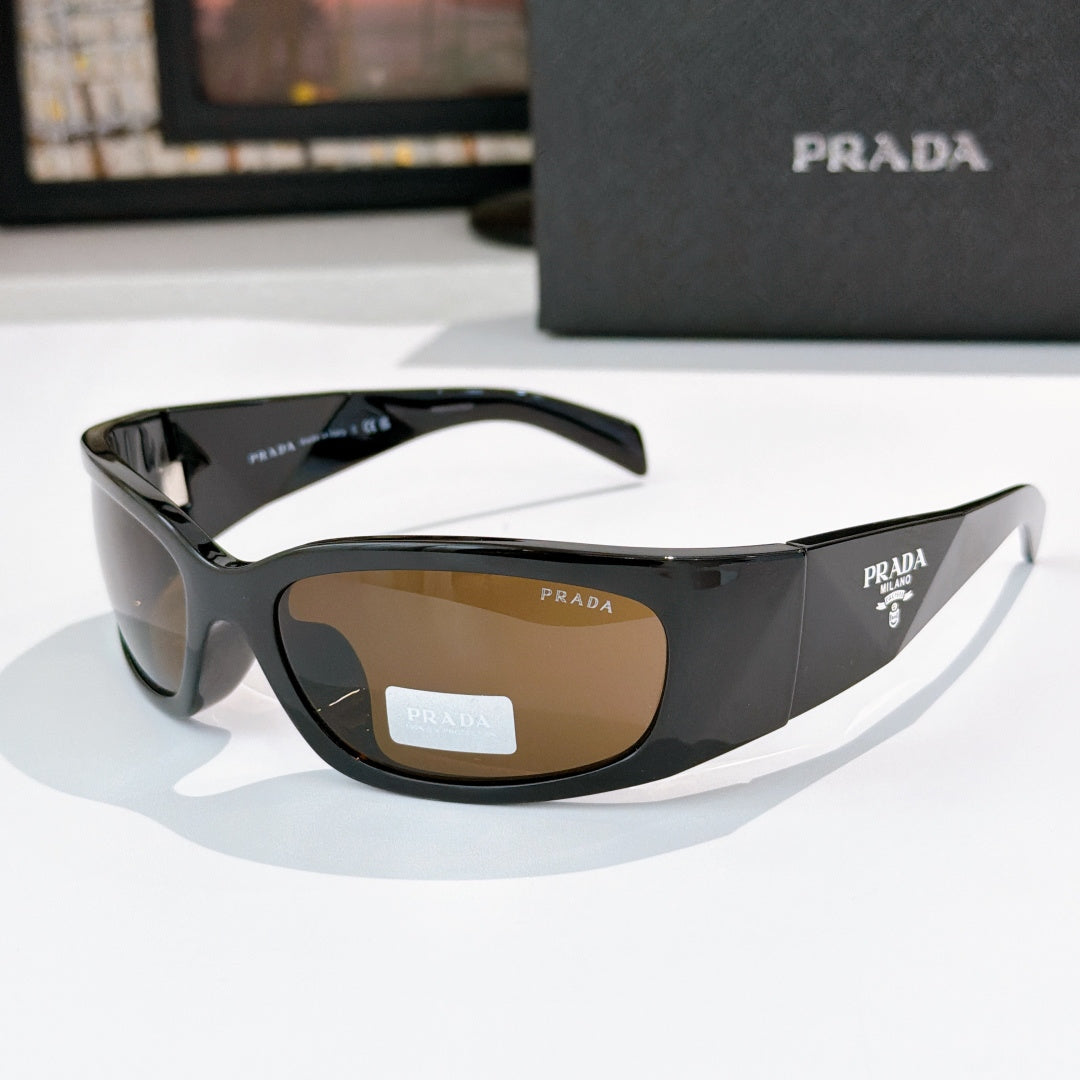Prada dark acetate glasses with amber-tinted lenses and logo hardware