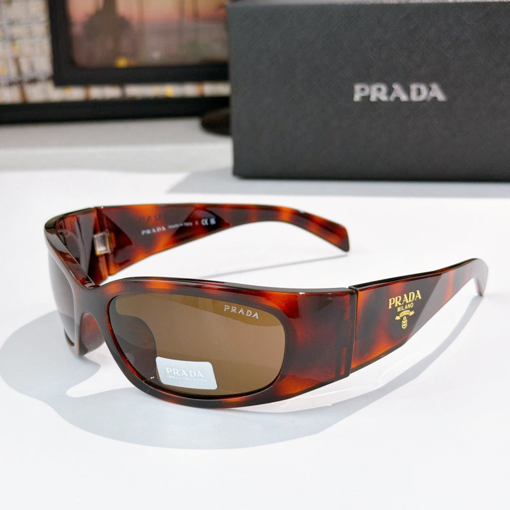 Prada tortoiseshell acetate glasses with amber lenses and metal logo hardware