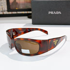 Prada tortoiseshell acetate glasses with amber lenses and metal logo hardware