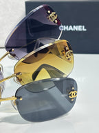 Stacked sunglasses with dark upper lens and gold mirror lens, logo temples