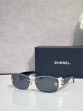 Gold-framed sunglasses with dark lenses and side logo detail, slim metal temples