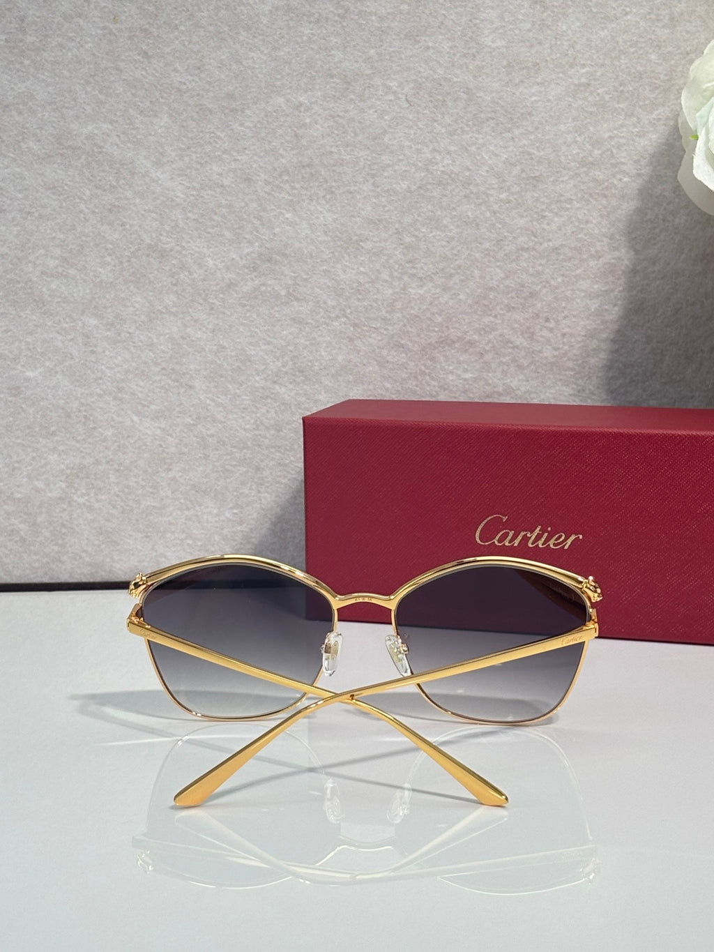 Cartier sunglasses with gold round frames and dark-tinted lenses