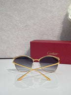 Cartier sunglasses with gold round frames and dark-tinted lenses