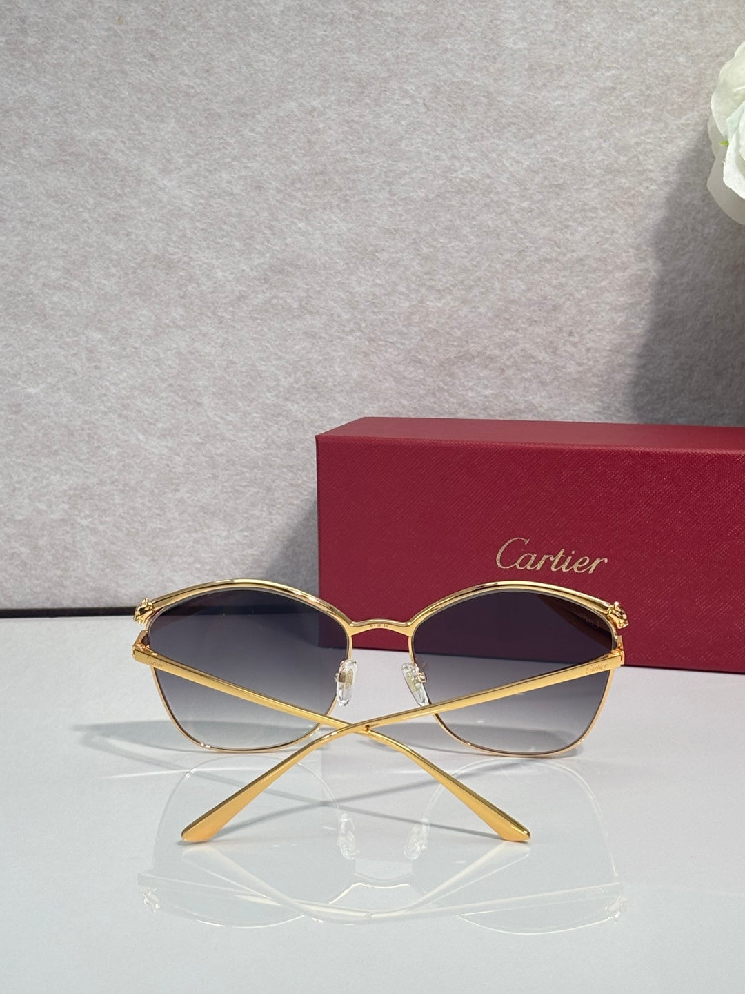 Cartier sunglasses with gold round frames and dark-tinted lenses