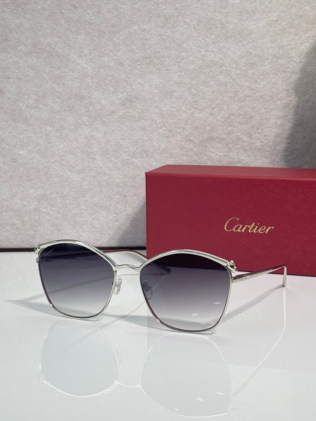 Cartier sunglasses with silver round frames and dark tinted lenses