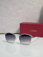 Cartier sunglasses with silver round frames and dark tinted lenses