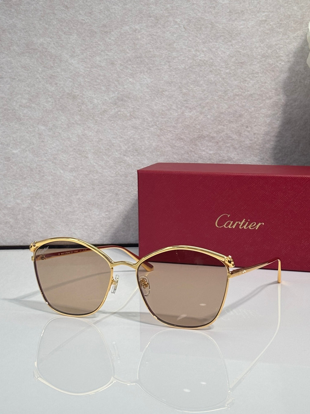 Cartier sunglasses with gold round frames and beige-tinted lenses