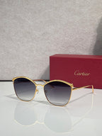 Cartier sunglasses with gold round frames and dark gradient lenses