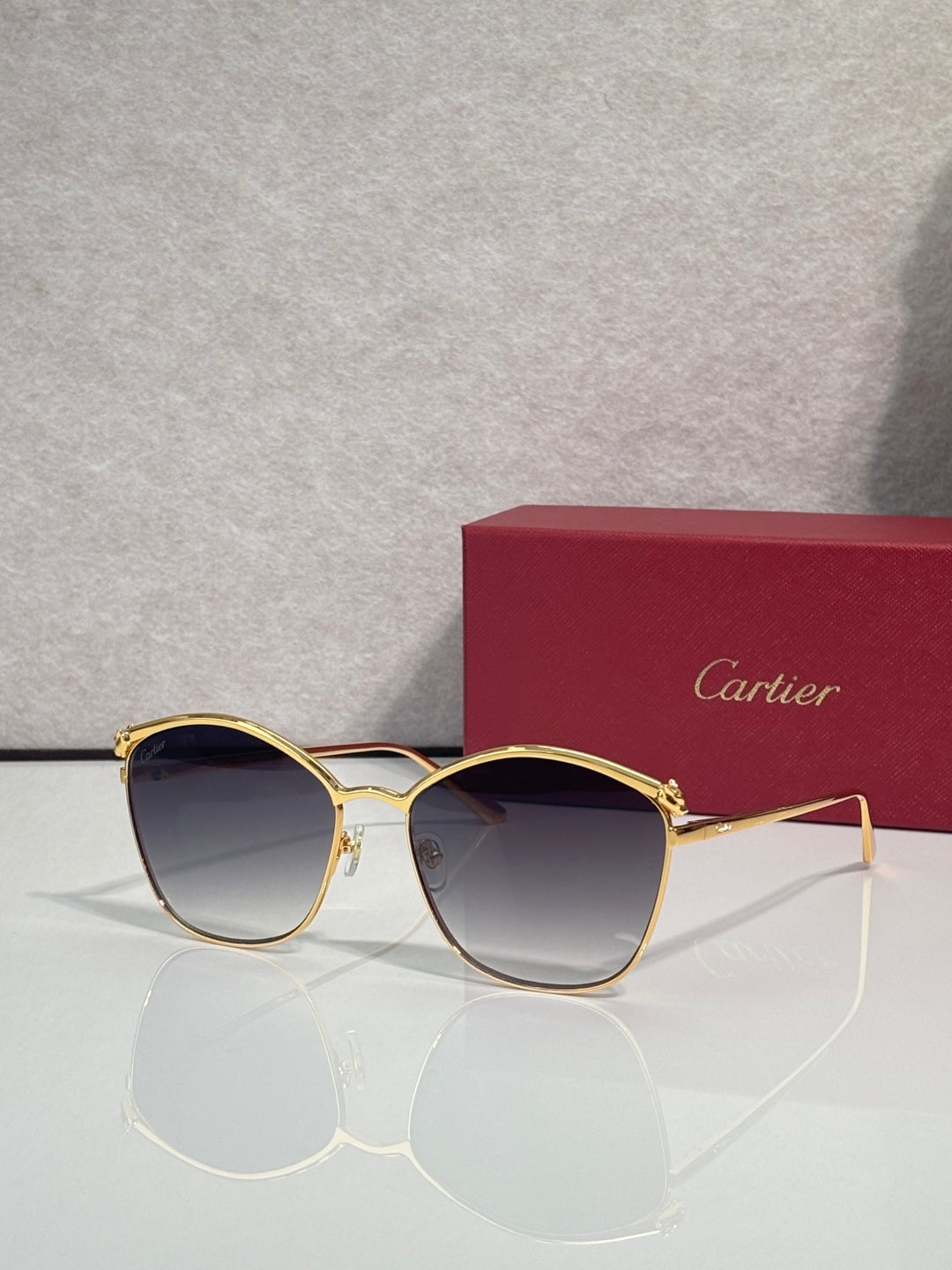 Cartier sunglasses with gold round frames and dark gradient lenses